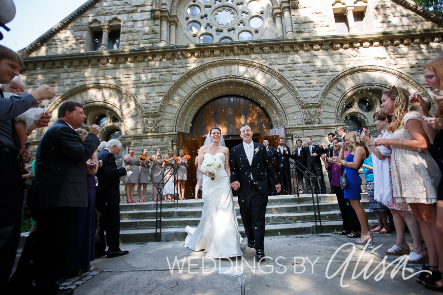 Bride and Groom exiting church with bubbles